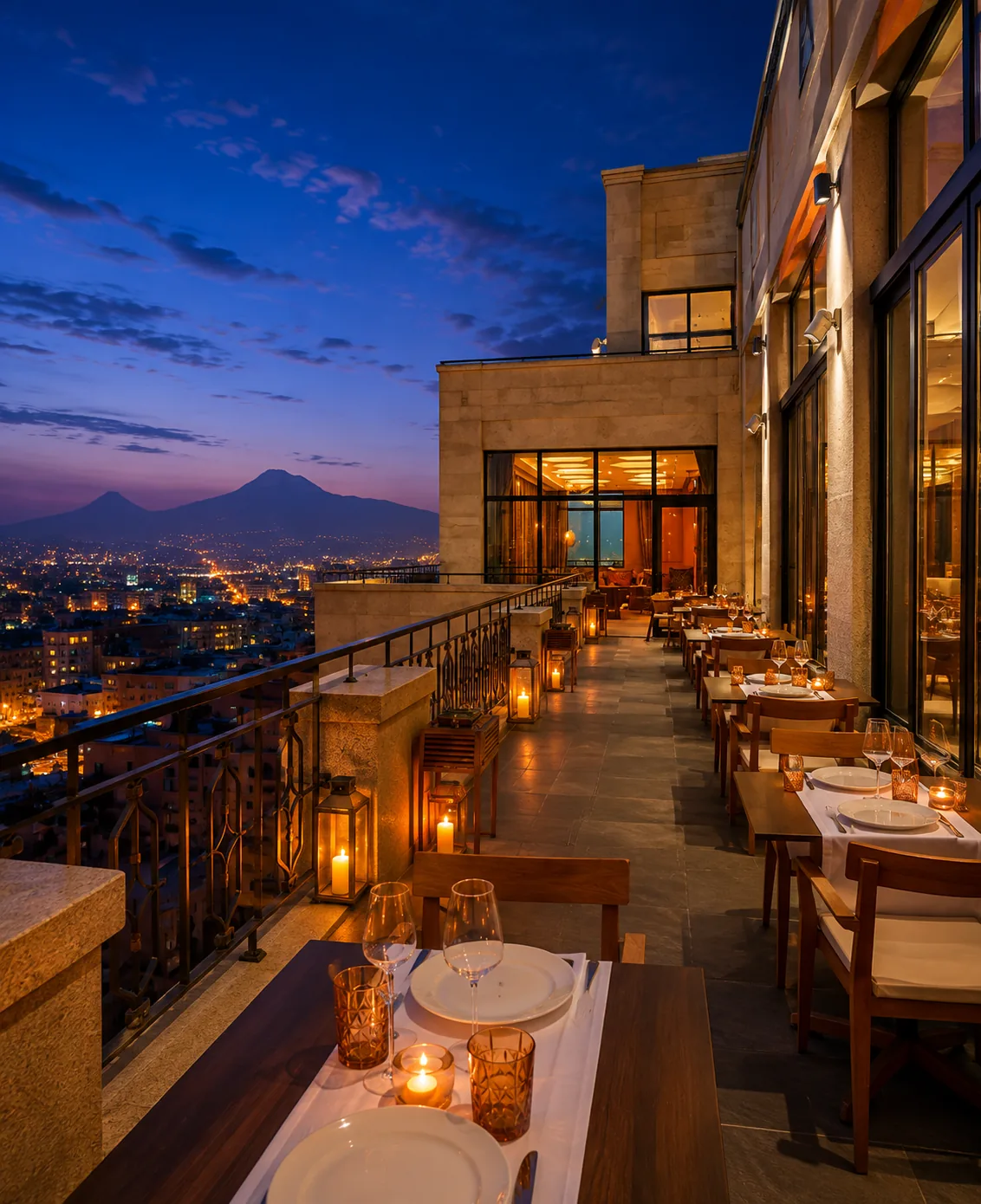 Candlelit rooftop terrace at The Alexander in Yerevan at dusk, with Mount Ararat in the distance