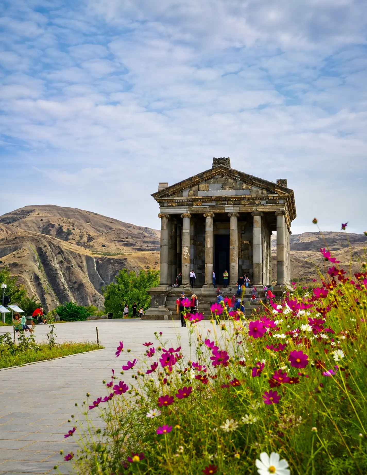 Garni pagan temple framed by wildflowers in bloom
